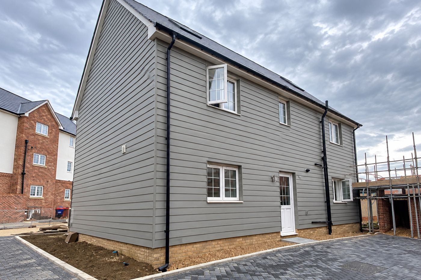 A new build house with grey weatherboard cladding